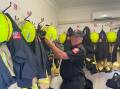 SIGNING OFF ONE LAST TIME: Robert Joseph hangs his helmet up for one last time with the Mudgee 387 Fire and Rescue NSW Station crew. Picture: SUPPLIED