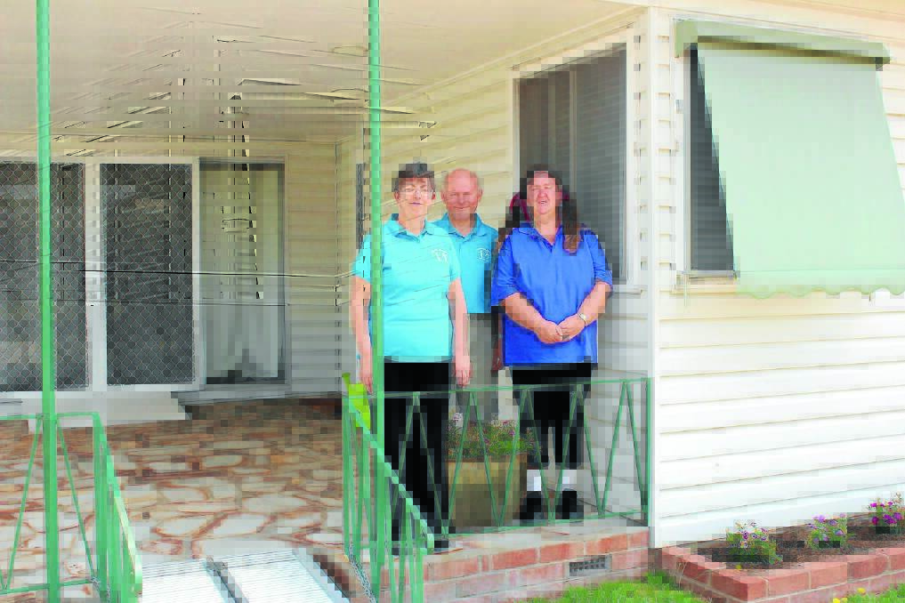 Susie Downing, Mark Kurtz and Sandra Eades of Mudgee Disability Service stand on the front porch of the new MDSS respite house, Mealey House.  070114\ls mdss\002