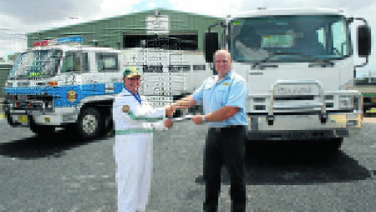 PAID FOR: Mudgee Rescue Squad President Geoff Hawes hands over the cheque for their new truck to Tracserv Truck Sales Consultant Daryl French on Tuesday.