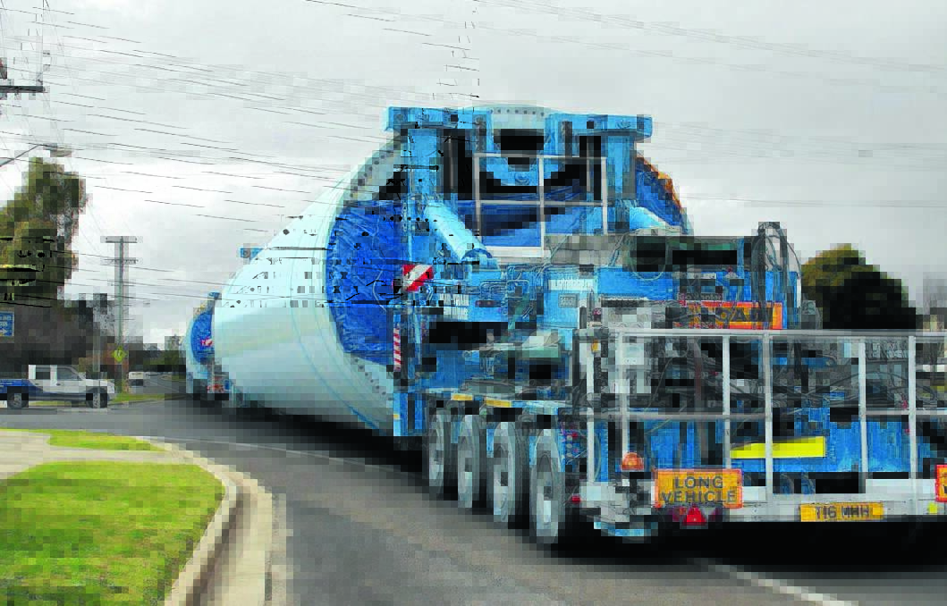 A Mid-Western Regional Council impression of a heavy vehicle transporting components to the Crudine Ridge Wind Farm through a local town street. 