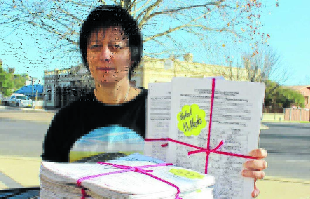 Colleen Holland with her petition signed by 11,116 people. She has thanked Mid-Western Regional Council and the community for their support in her campaign to have Ulan Road upgraded but reminded council that the petition also included Cope Road. 