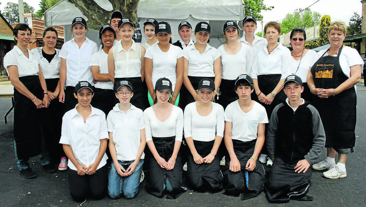 Kandos High School students joined volunteers Leonie Baimbridge, Jenny Murray, Amanda Herbert, Kay Cooke and Robyn Oakes to serve four “waves” of 302 people at the Long Lunch in Louee Street on Saturday.	031112/rmstreetfeast/002