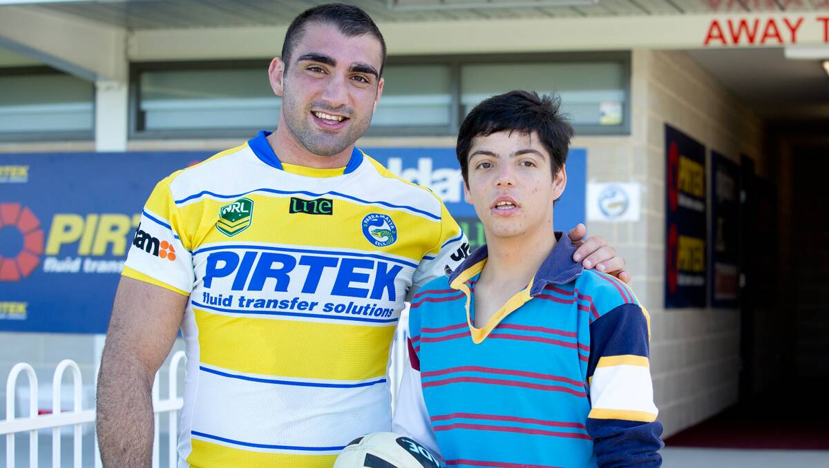 HAVING A BALL: Jacob Mick meets Parramatta captain Tim Mannah at the Eels training session on Saturday at Glen Willow.