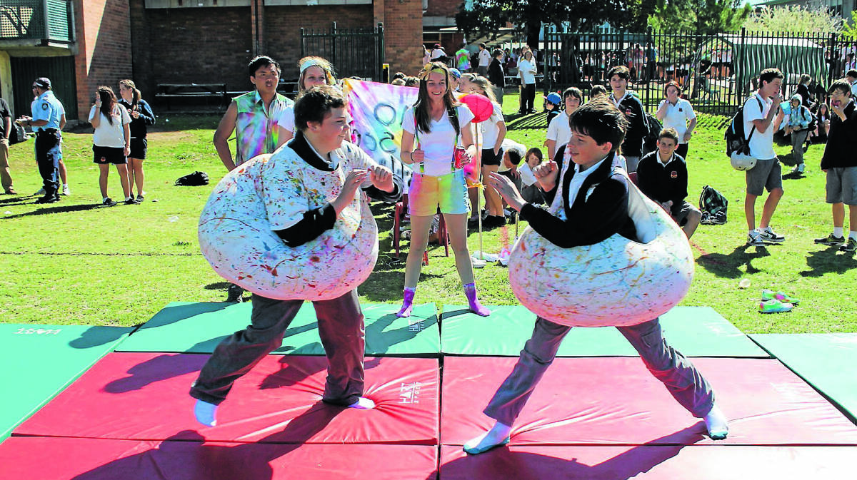 CHARGE: Sam McFarlane and Nick Dziura go head to head in the sumo game at the Rainbow Day Fete.