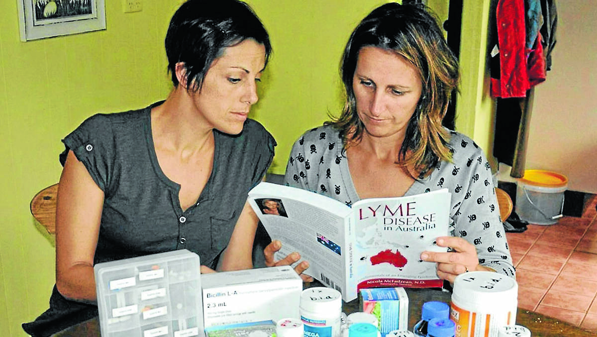 Lisa Tubnor (right) with her sister, Melanie Lattanizo, and some of the medication needed to fight Lyme disease. 070313/lyme